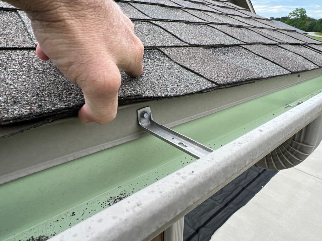 granules-from-shingles-collecting-in-the-gutters-are-a-sign-you-need-roof-repair